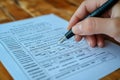 Completing application form with pen on wooden table in an office setting Royalty Free Stock Photo