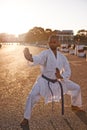 Completing his kata. A young karate professional practicing while wearing a gi.