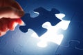 Completing the last piece of jigsaw puzzle. Solution Royalty Free Stock Photo