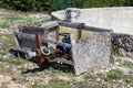 Complex connection of multiple pipeline connectors with metal valve connected with strong screws next to large abandoned concrete