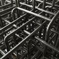 A complex, intertwined network of metal pipes forming a three-dimensional grid. The Royalty Free Stock Photo