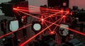 Complex laser beam system with red light, optics, and mirrors Royalty Free Stock Photo