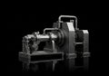 A complex mechanical device is set against a black background. The machine features industrial Royalty Free Stock Photo