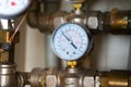 Complex piping system with hot analog pressure gauge with dust, dirt, dirty stains. water manifold with manometer and Royalty Free Stock Photo