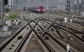 Complex railway switchyard with multiple tracks and approaching train Royalty Free Stock Photo