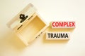 Complex trauma symbol. Concept words Complex trauma on wooden block. Beautiful white table white background. Empthy opened wooden