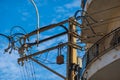 Complex web of power lines and transformers against clear blue sky Royalty Free Stock Photo