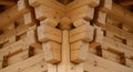 Complex wooden log construction corner joint showing interlocking timber beams with precise notched craftsmanship and natural wood Royalty Free Stock Photo