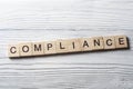 Compliance word written on wood abc block at wooden background. Royalty Free Stock Photo