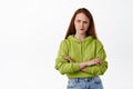 Complicated redhead girl looks puzzled, frowning and sulking while thinking, look aside and makes decision, feel