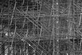 Complicated scaffolding consisting of many poles and struts inside a historic building, black and white