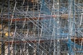 Complicated scaffolding consisting of many poles and struts inside a historic building.