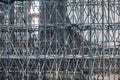 Complicated scaffolding consisting of many poles and struts inside a historic building