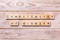 Complication of disease word written on wood block. complication of disease text on wooden table for your desing, coronavirus