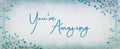 Compliment or encouragement typography design saying you`re amazing in cursive handwriting with ivy or vine border design and blu