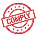 COMPLY text written on red vintage stamp