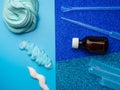 Components to make slime. Child education concept. On blue surface slime, toothpaste, shaving foam, Sodium tetraborate decahydrate