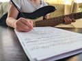 Composer child girl hand writing notes in notebook closeup Royalty Free Stock Photo