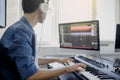 Composer hands on piano keys in recording studio. music production technology, man is working on pianino and computer