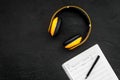Composer office desk . Workplace of musician with headphones and notes black background top view mockup Royalty Free Stock Photo