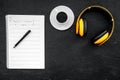 Composer office desk . Workplace of musician with headphones and notes black background top view mockup Royalty Free Stock Photo