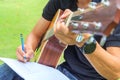 Composer write note of song and use acoustic guitar Royalty Free Stock Photo