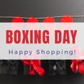 Composite of boxing day, happy shopping text over gift boxes and red tags on black background Royalty Free Stock Photo