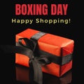 Composite of boxing day and happy shopping text over red gift box on black background, copy space Royalty Free Stock Photo