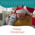 Composite of caucasian smiling boy in santa hat embracing father on sofa and happy christmas text