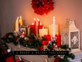 Composite of christmas greetings text over christmas candles and decorations Royalty Free Stock Photo