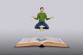 Composite collage image of concentrated small guy meditate fly above huge opened book isolated on grey background