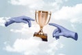 Composite collage picture of two blue human arms fingers reach touch award cup isolated on creative clouds sky Royalty Free Stock Photo