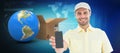 Composite 3d image of handsome delivery man showing mobile phone Royalty Free Stock Photo