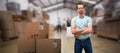 Composite 3d image of serious warehouse manager standing with arms crossed Royalty Free Stock Photo