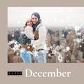 Composite of happy december text over caucasian couple in winter hats