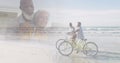 Composite of happy diverse senior using laptop at home, and on bikes at beach Royalty Free Stock Photo