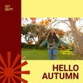 Composite of hello autumn text over happy biracial woman in autumn park