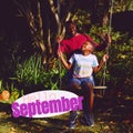 Composite of hello september text over african american father with son in garden