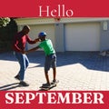 Composite of hello september text over african american father with son in garden