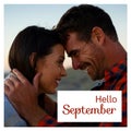 Composite of hello september text over caucasian couple on beach