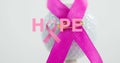 Composite of hope text with pink awareness ribbon pinned on white ball, copy space