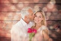 Composite image of affectionate man kissing his wife on the cheek with roses Royalty Free Stock Photo