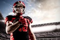 Composite image of american football player in helmet holding rugby ball Royalty Free Stock Photo