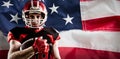 Composite image of american football player in helmet holding rugby ball Royalty Free Stock Photo