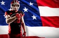 Composite image of american football player in helmet holding rugby ball Royalty Free Stock Photo