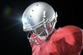 Composite image of american football player looking down Royalty Free Stock Photo