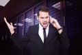 Composite image of angry businessman gesturing on the phone Royalty Free Stock Photo