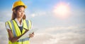 Composite image of architect woman with yellow helmet and plans Royalty Free Stock Photo