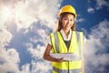 Composite image of architect woman with yellow helmet and plans Royalty Free Stock Photo