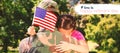 Composite image of army man hugging daughter with american flag Royalty Free Stock Photo